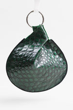 Load image into Gallery viewer, Turbine by Lisa Draper-Murphy green alligator print wristlet with silver bangle.
