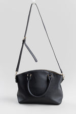Load image into Gallery viewer, H&amp;Co black faux leather handbag with gold-tone hardware and a red heart charm.
