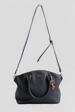 Load image into Gallery viewer, H&amp;Co black faux leather handbag with gold-tone hardware and a red heart charm.
