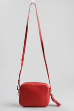 Load image into Gallery viewer, Aurora London red leather rectangular camera bag with long strap and gold-tone hardware.
