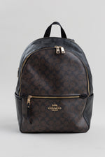 Load image into Gallery viewer, Coach black and brown charlie backpack in signature coated front panel with gold-tone hardware.
