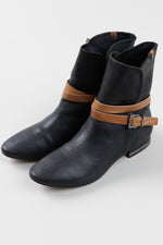Load image into Gallery viewer, BCBG Max Azria black pebble leather booties with tan strap detail (37)
