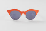 Load image into Gallery viewer, Swatch orange and white frosted sunglasses with round, blue toned reflective lenses.
