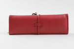 Load image into Gallery viewer, Birks red leather jewelry travel case with tie closure and interior organization pockets and straps.
