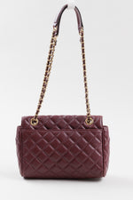 Load image into Gallery viewer, Michael Kors burgandy leather cross body shoulder bag with gold chain strap and gold metal tab closure.
