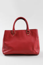 Load image into Gallery viewer, Michael Kors red leather rolled handle purse with gold MK medallion.
