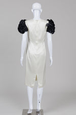 Load image into Gallery viewer, Amiel Monde black and champagne satin dress with black ruffled sleeves and bow with shoulder pads with small stain on inside lining
