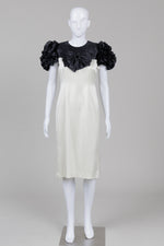 Load image into Gallery viewer, Amiel Monde black and champagne satin dress with black ruffled sleeves and bow with shoulder pads with small stain on inside lining

