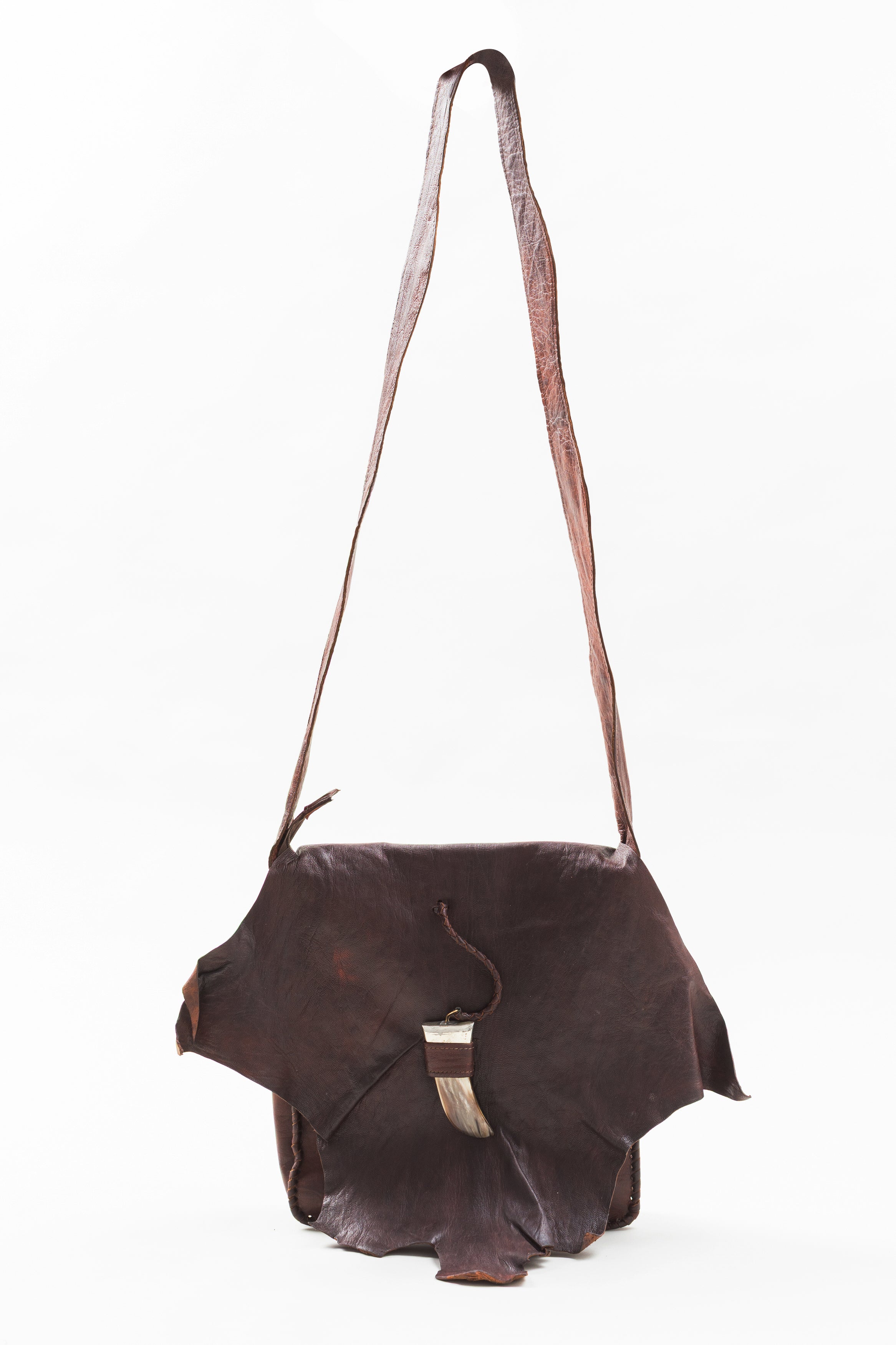 Hand Crafted leather messenger bag with horn detail.